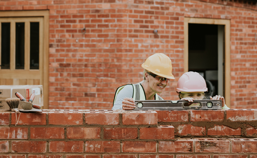 Picture of two people building a wall